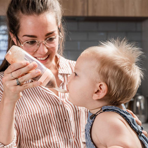 Baby bottle best sale with spoon attached